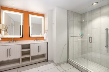 A bathroom vanity next to the shower area